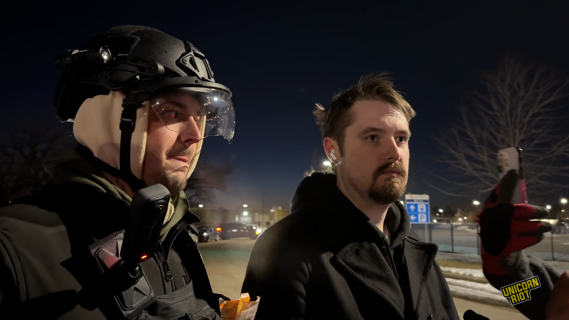 Nick Sortor and Cam Higby stand outside the Whipple Federal Building in Minneapolis on Jan. 11 — the same night Sortor hit a woman protester and drove through the crowd.